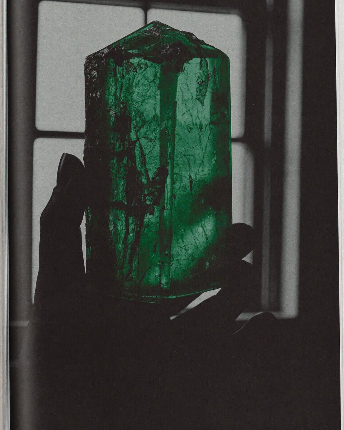 An emerald crystal held to the light