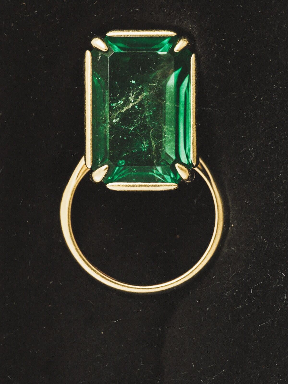 Loose emeralds on paper